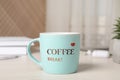 Mug with inscription Coffee Break on white wooden table in office Royalty Free Stock Photo