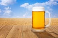 Mug of beer against wheat field Royalty Free Stock Photo