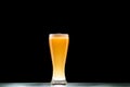 mug of light cold beer with foam at table on black background Royalty Free Stock Photo