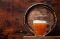 Mug of light lager beer and old wooden barrel Royalty Free Stock Photo