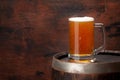 Mug of light lager beer and old wooden barrel Royalty Free Stock Photo