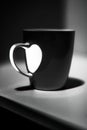 Mug in lights and shadow in black and white with handle forming Royalty Free Stock Photo