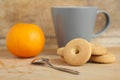 Mug of milk with cookies and orange