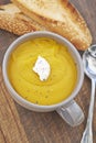 Mug of pumpkin soup and toasted bread