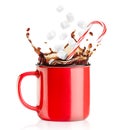 mug with a splash of coffee and falling candy cane with marshmallows Royalty Free Stock Photo