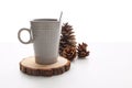 A mug with a spoon over a wooden coaster Royalty Free Stock Photo