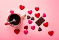 Mug with sugar and chocolate hearts on pink background. Flat lay composition. Romantic, St Valentines Day concept