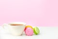 Mug on the table and colored biscuits on a white wooden table Royalty Free Stock Photo