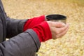 mug of tea, coffee in hands woman in autumn Park Royalty Free Stock Photo