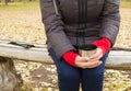 mug of tea, coffee in hands woman in autumn Park Royalty Free Stock Photo