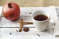 Mug of tea, pomegranate and cinnamon on a wooden tray Royalty Free Stock Photo