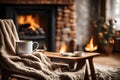 A mug of tea stands on a chair with a woolen blanket in a cozy living room with a fireplace Royalty Free Stock Photo