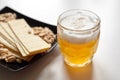 Mug of unfiltered light wheat beer with beer snacks on white table Royalty Free Stock Photo