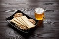 Mug of unfiltered light wheat beer with beer snacks on wooden table Royalty Free Stock Photo