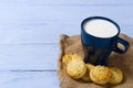 Mug of warm milk and cookies before bed. Blue cup with fresh milk and tasty cookies. Royalty Free Stock Photo
