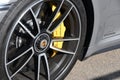 Mugello Circuit, Italy - 23 September 2021: detail of an alloy wheel rim with yellow brake caliper of a Porsche 911 in the paddock Royalty Free Stock Photo