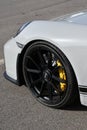 Mugello Circuit, Italy - 23 September 2021: detail of an alloy wheel rim with yellow brake caliper of a Porsche 911 in the paddock Royalty Free Stock Photo