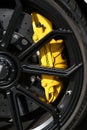 Mugello Circuit, Italy - 23 September 2021: detail of an alloy wheel rim with yellow brake caliper of a Porsche 911 in the paddock Royalty Free Stock Photo