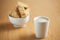 A mugg of coffee with a bowl of rusks in the background Royalty Free Stock Photo