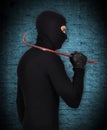 Mugger in mask with nail puller Royalty Free Stock Photo