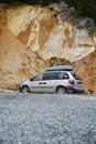 Mugla, Turkey - 23 December 2022: A silver Dodge Caravan minivan type car with a roof rack on the background of a quarry