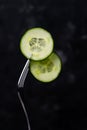 mugs of green cucumber on a fork