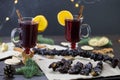 Mugs of warm wine with an orange, and cookies, ingredients on a wooden brown table. Traditional hot drink for Christmas, with Royalty Free Stock Photo