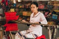 MUI NE, VIETNAM - MARCH 6, 2017: Woman Asian weaver working on a traditional loom for yarn silk Royalty Free Stock Photo