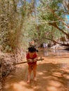 Muine, Vietnam, Fairy Stream. River, red canyon. Little Vietnamese girl playing by the swing.