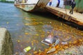 Muisne, Ecuador - March 16, 2016: Different trash floating in the water next to ferry pier