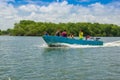 Muisne, Ecuador - March 16, 2016: Group of people, adults and kids inside typical blue fishingboat driving alongside