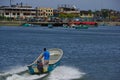 Muisne, Ecuador - March 16, 2016: Man standing inside typical fishing boat crossing water from Muisne to mainland