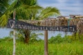 Muisne, Ecuador - March 16, 2016: Small charming bamboo construction with wooden sign saying bienvenidos a isla bonita Royalty Free Stock Photo