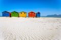 Muizenberg beach with white sand and colorful wooden cabins in Cape Town