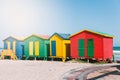 Muizenberg beach with white sand and colorful wooden cabins in Cape Town
