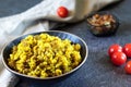 Mujadara: lentils, rice and fried onions on dark background with light textiles