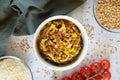 Mujadara - lentils and rice pilaf with fried onions on light background.