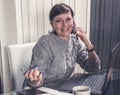 Happy business woman talking on mobile phone in front of laptop in office. Success business, People smiling working Royalty Free Stock Photo