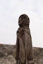 Wooden sculpture of a grieving elderly woman on the territory of Palanok castle in Mukachevo