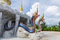 Mukdahan, Thailand - July 31, 2022: Two Nagas at the entrance of the pagoda at Wat Dan Phra In, Nikhom Kham Soi, Mukdahan,