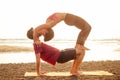 Muladhara swadhisthana manipula tantra yoga on the beach man and woman meditates sitting on the sand by the sea at