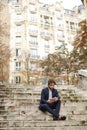 Mulatto businessman using tablet and sitting on steps. Royalty Free Stock Photo