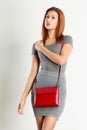 Mulatto girl gray wear with red handbag Royalty Free Stock Photo