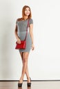 Mulatto girl gray wear with red handbag Royalty Free Stock Photo