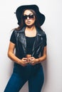 Mulatto girl wearing sunglasses and black hat over a white background. Royalty Free Stock Photo