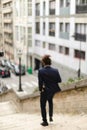 Mulatto guy walking down steps with newspaper. Royalty Free Stock Photo