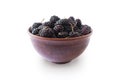 Mulberries in bowl isolated on white background. Black mulberry on white background. Ripe and tasty berry with copy space for text