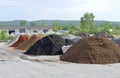 Mulch and gravel piles in front of a packaging plant Royalty Free Stock Photo