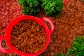 Mulching soil cover made of natural materials.Decorative chips for the garden.Red chips for mulching in red silicone Royalty Free Stock Photo