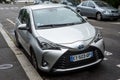 Front view of grey Toyota Yaris hybrid car parked in the street